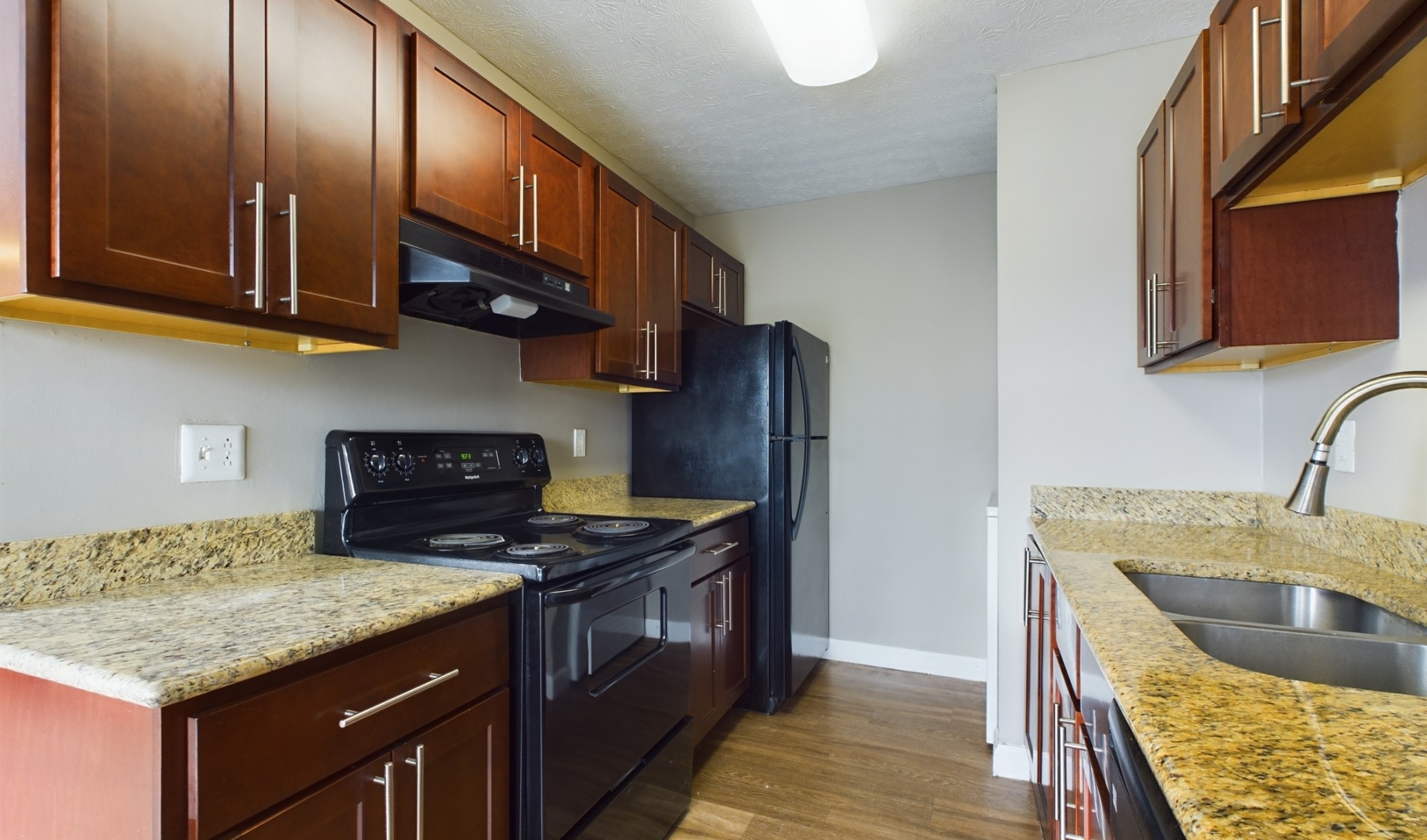 Where Memories are Cooked kitchen with black appliances and large sink
